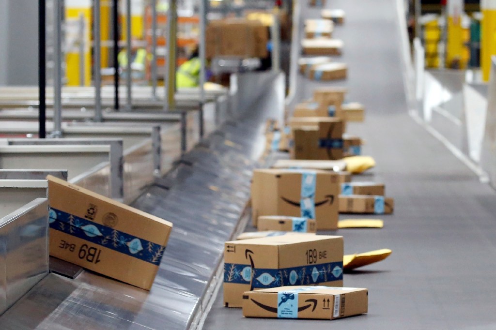 FILE - Amazon packages move along a conveyor at an Amazon warehouse facility in December. 17, 2019, in Goodyear, Ariz. July sales events have become a seasonal revenue driver for the retail industry since Amazon first launched Prime Day in 2015. 